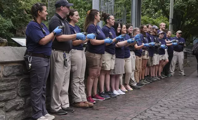 Director of Herpetology Lauren Augustine, left, and staff members pose for photograph s during the debut of 16 critically endangered western Santa Cruz tortoise hatchlings at the Philadelphia Zoo in Philadelphia, Wednesday, Aug. 20, 2025. (AP Photo/Matt Rourke)