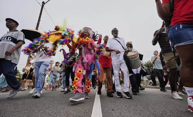 People form a second line parade during an event to commemorate the 20th anniversary of Hurricane Katrina, in the Lower Ninth Ward of New Orleans, Friday, Aug. 29, 2025. (AP Photo/Alex Brandon)