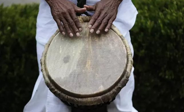 Luther Gray of the Congo Square Preservation Society plays a traditional African drum during an event to commemorate the 20th anniversary of Hurricane Katrina in New Orleans, Friday, Aug. 29, 2025. (AP Photo/Gerald Herbert)