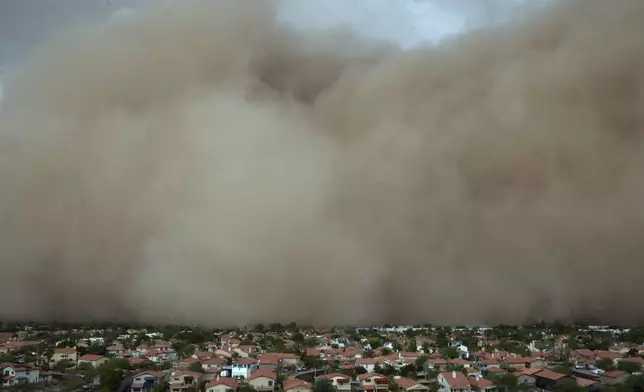 A giant dust storm approaches the Phoenix metro area as a monsoon storm pushes the dust into the air, Monday, Aug. 25, 2025, in Phoenix. (AP Photo/Ross D. Franklin)