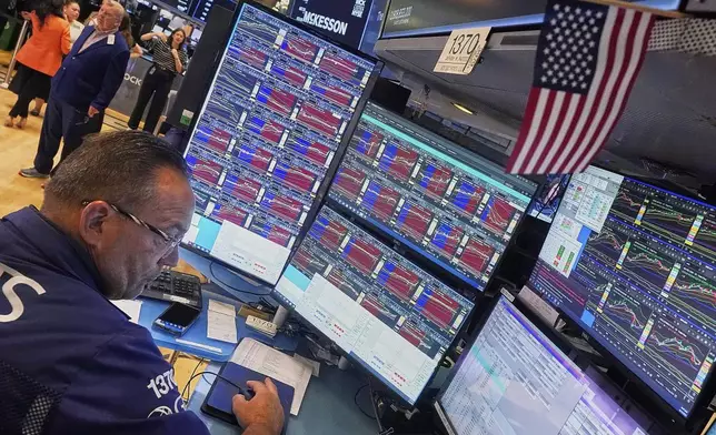 Specialist Anthony Matesic works at his post on the floor of the New York Stock Exchange, Wednesday, Aug. 13, 2025. (AP Photo/Richard Drew)