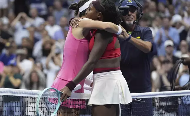 Coco Gauff, of the United States, right, and Ajla Tomljanovic, of Australia, left, embrace across the net after Gauff won their match during the first round of the U.S. Open tennis championships, Tuesday, Aug. 26, 2025, in New York. (AP Photo/Frank Franklin II)