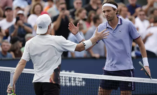 Arthur Rinderknech, of France, right, shakes hands with Alejandro Davidovich Fokina, of Spain, after winning their second-round match of the U.S. Open tennis championships, Wednesday, Aug. 27, 2025, in New York. (AP Photo/Adam Hunger)