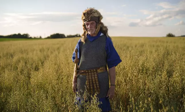 Andrei Tase poses for a portrait, wearing a Roman soldier outfit, in Poiana, Romania, Saturday, July 12, 2025, during the Getodava historical reenactment festival. (AP Photo/Vadim Ghirda)