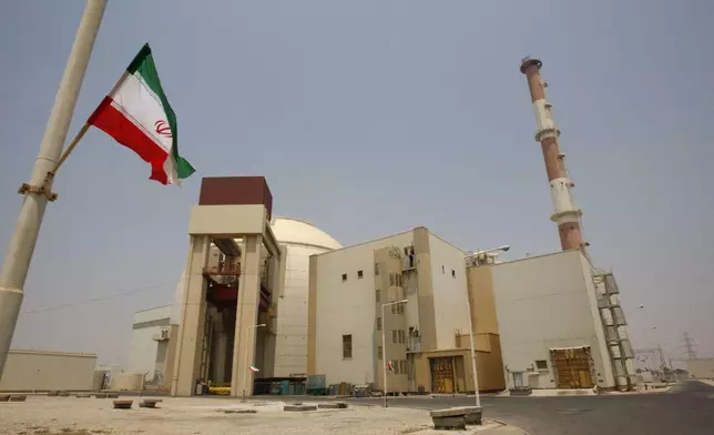 FILE -An Iranian flag flutters in front of the reactor building of the Bushehr nuclear power plant, just outside the southern city of Bushehr, Iran, Saturday, Aug. 21, 2010. (AP Photo/Vahid Salemi, File)