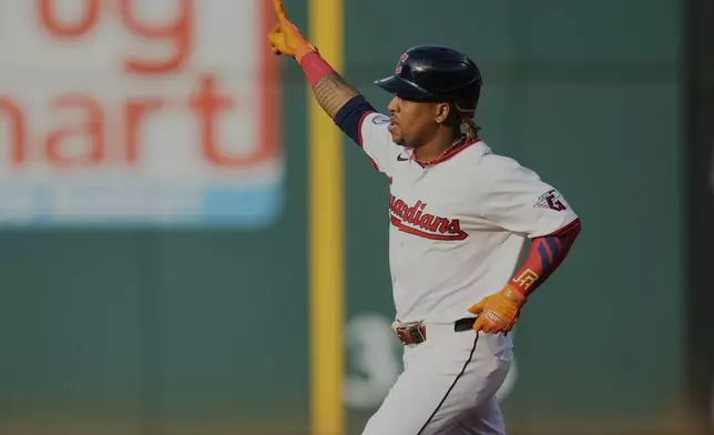 Cleveland Guardians' Jose Ramirez gestures as he runs the bases with a home run in the first inning of a baseball game against the Miami Marlins in Cleveland, Tuesday, Aug. 12, 2025. (AP Photo/Sue Ogrocki)
