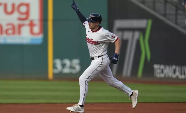Cleveland Guardians' Kyle Manzardo (9) gestures as he runs the bases with a home run in the first inning of a baseball game against the Miami Marlins in Cleveland, Tuesday, Aug. 12, 2025. (AP Photo/Sue Ogrocki)