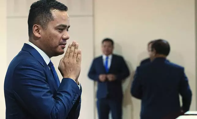 Cambodian Deputy Prime Minister and Minister of Interior Sar Sokha, left, greets before the session on the draft law on amending the law on nationality at the National Assembly in Phnom Penh Cambodia, Monday, Aug. 25, 2025. (AP Photo/Heng Sinith)