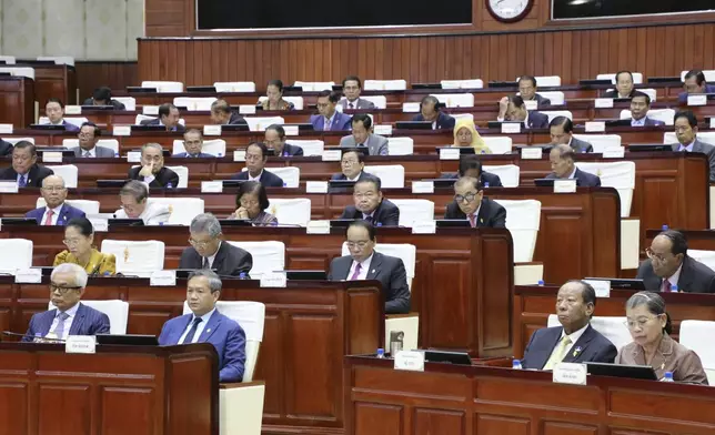 In this photo released by the Cambodia National Assembly, Cambodian Prime Minister Hun Manet, second left, front row, sits together with other lawmakers during the session on the draft law on amending the law on nationality at the National Assembly in Phnom Penh Cambodia, Monday, Aug. 25, 2025. (Cambodia National Assembly via AP)