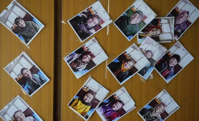 Photographs of street children studying at an informal school are displayed on a board in Kabul, Afghanistan, Thursday, June 12, 2025. (AP Photo/Ebrahim Noroozi)