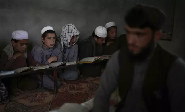 Afghan boys attend a Quran class at the Abdullah Ibn-Masoud religious school on the outskirts of Kabul, Afghanistan, Monday, May 26, 2025. (AP Photo/Ebrahim Noroozi)