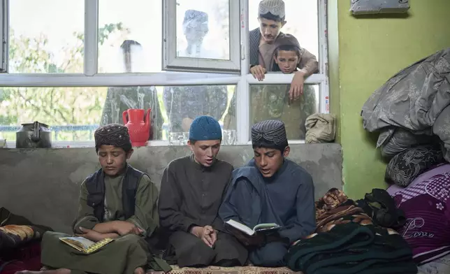 Afghan boys read the Quran at the Imam al-Tirmidhi religious school in Kabul, Afghanistan, Wednesday, June 11, 2025. (AP Photo/Ebrahim Noroozi)