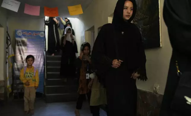 Afghan girls studying at an informal school walk through the school in Kabul, Afghanistan, Thursday, June 12, 2025. (AP Photo/Ebrahim Noroozi)