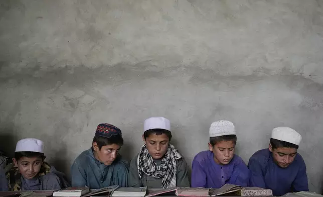 Afghan boys attend a Quran class at the Abdullah Ibn-Masoud religious school on the outskirts of Kabul, Afghanistan, Monday, May 26, 2025. (AP Photo/Ebrahim Noroozi)