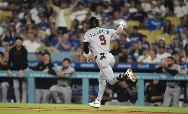 Arizona Diamondbacks' Blaze Alexander gestures toward his dugout after hitting a two-run home run during the fourth inning of a baseball game against the Los Angeles Dodgers, Friday, Aug. 29, 2025, in Los Angeles. (AP Photo/Mark J. Terrill)