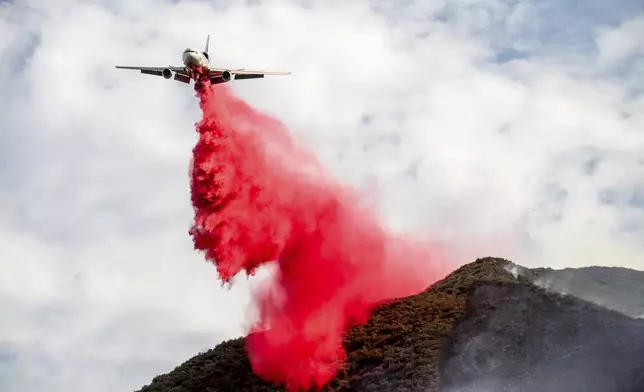 An air tanker drops retardant on the Gifford Fire burning on Monday, Aug. 4, 2025, in Los Padres National Forest, Calif. (AP Photo/Noah Berger)