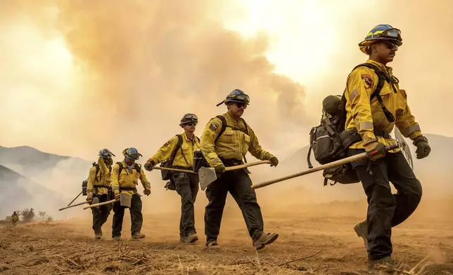 Firefighters battle the Gifford Fire burning on Monday, Aug. 4, 2025, in Los Padres National Forest, Calif. (AP Photo/Noah Berger)