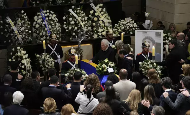 Miguel Uribe, the father of presidential hopeful and opposition Sen. Miguel Uribe, touches his son's coffin, at Congress in Bogota, Colombia, Monday, Aug. 11, 2025, after the senator died from wounds suffered when he was shot at a political rally. (AP Photo/Fernando Vergara)