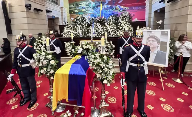 The coffin of presidential hopeful and opposition Sen. Miguel Uribe, who died from wounds suffered when he was shot at a political rally, lies in state at Congress in Bogota, Colombia, Tuesday, Aug. 12, 2025. (AP Photo/Ivan Valencia)