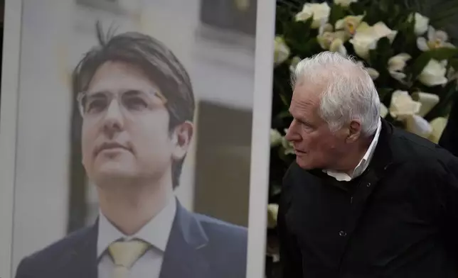 Miguel Uribe, the father of opposition Sen. and presidential hopeful Miguel Uribe, who died from wounds suffered when he was shot during a political rally, arrives at Congress in Bogota, Colombia, for a ceremony honoring his son, Monday, Aug. 11, 2025. (AP Photo/Fernando Vergara)