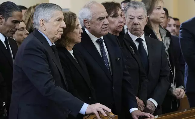 Colombia's former presidents, Cesar Gaviria, left, Ernesto Samper, and Juan Manuel Santos, right, attend the funeral mass for presidential hopeful and opposition Sen. Miguel Uribe, who died of gunshot wounds sustained at a political rally, in Bogota, Colombia, Wednesday, Aug. 13, 2025. (AP Photo/Fernando Vergara)