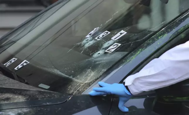 FILE - Crime scene investigators work at the site where the personal secretary and an advisor to Mexico City's mayor were killed by gunmen on a motorcycle, in Mexico City, May 20, 2025. (AP Photo/Tristan Velazquez, File)