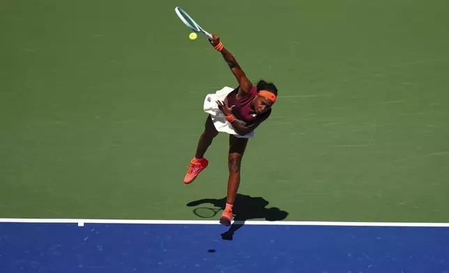 Coco Gauff, of the United States, serves against Magdalena Frech, of Poland, during the third round of the U.S. Open tennis championships, Saturday, Aug. 30, 2025, in New York. (AP Photo/Kirsty Wigglesworth)