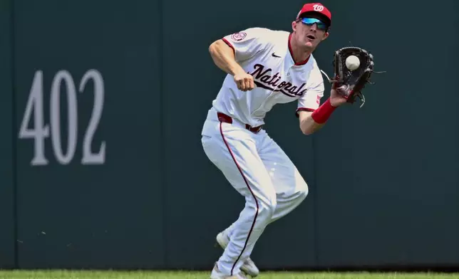Washington Nationals center fielder Jacob Young catches a deep fly ball hit by the Athletics' Shea Langeliers during the first inning of a baseball game Thursday, Aug. 7, 2025, in Washington. (AP Photo/John McDonnell)