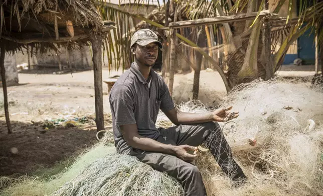 CORRECTS SPELLING TO NDURE NOT NUDURE Fisherman Salif Ndure shows some of his unusable nets damaged by trawlers, at Gunjur, Gambia, on March 23, 2025. (AP Photo/Grace Ekpu)
