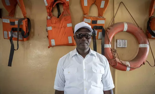 Abdou Sanyang, secretary general of the Association of Gambia Sailors, stands for a portrait in his office in Banjul, Gambia, on March 24, 2025. (AP Photo/Grace Ekpu)