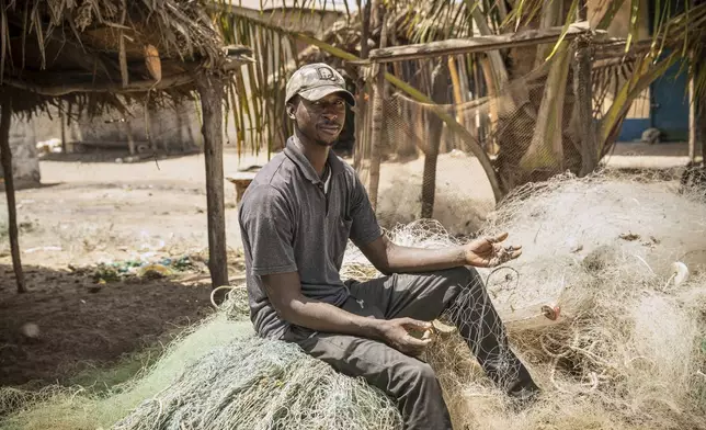 Fisherman Salif Nudure shows some of his unusable nets damaged by trawlers, at Gunjur, Gambia, on March 23, 2025. (AP Photo/Grace Ekpu)