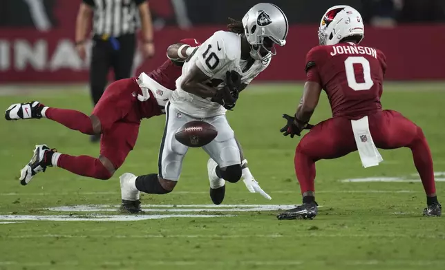 Las Vegas Raiders wide receiver Dont'e Thornton Jr. (10) can't make the catch as Arizona Cardinals safety Budda Baker (3) defends during the first half of an NFL preseason football game, Saturday, Aug. 23, 2025, in Glendale. (AP Photo/Rick Scuteri)