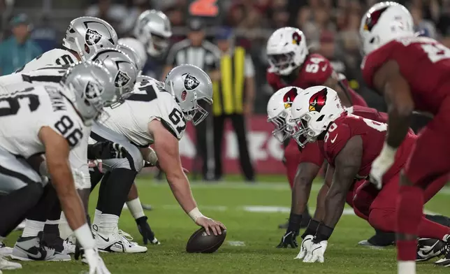 The Las Vegas Raiders and the Arizona Cardinals line up during the first half of an NFL preseason football game, Saturday, Aug. 23, 2025, in Glendale. (AP Photo/Rick Scuteri)