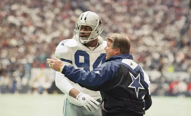 FILE - Dallas Cowboys' coach Jimmy Johnson, right confers with defensive end Charles Haley in the first half of their NFC championship game against the San Francisco 49ers, Jan. 23, 1994, in Irving, Texas. (AP Photo/Linda Kaye, File)