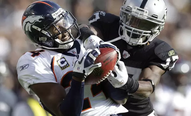 FILE - Denver Broncos cornerback Champ Bailey, right, intercepts a pass intended for Oakland Raiders wide receiver Denarius Moore in the second quarter of an NFL football game in Oakland, Calif., Nov. 6, 2011. (AP Photo/Ben Margot, File)