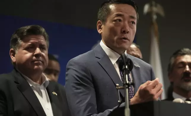 CORRECTS CITY TO AURORA, ILL., Texas Rep. Gene Wu speaks as Illinois Governor JB Pritzker looks on during a news conference in Aurora, Ill,, on Tuesday, Aug 5, 2025. (AP Photo/Erin Hooley)