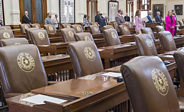 Empty chairs belonging to House Democrats remain empty during a session convocation in the State Capitol, Tuesday, Aug. 5, 2025, in Austin, Texas. (AP Photo/Rodolfo Gonzalez)