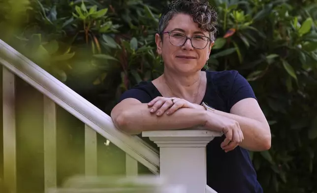 Ziva Mann, mother of a transgender child and member of a welcoming synagogue, poses outside her home, Wednesday, Aug. 13, 2025, in Newton, Mass. (AP Photo/Charles Krupa)