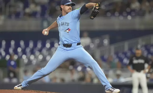 Toronto Blue Jays starting pitcher Shane Bieber aims a pitch during the first inning of a baseball game against the Miami Marlins, Friday, Aug. 22, 2025, in Miami. (AP Photo/Marta Lavandier)