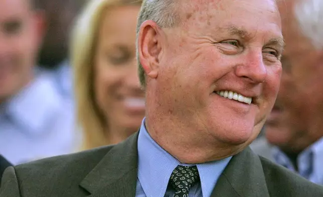 FILE - H.A. 'Humpy' Wheeler, right, president of Lowe's Motor Speedway smiles during a joint session of the General Assembly in the Senate Chamber May 10, 2005 in Raleigh, N.C. (AP Photo/Gerry Broome, file)