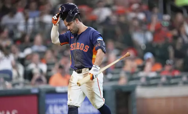 Houston Astros' Jose Altuve walks back to the dugout after striking out against the Baltimore Orioles during the fourth inning of a baseball game Sunday, Aug. 17, 2025, in Houston. (AP Photo/David J. Phillip)