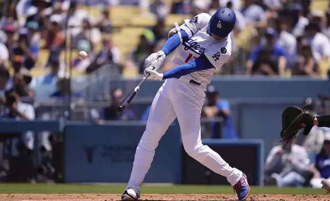 Los Angeles Dodgers' Shohei Ohtani hits a two-run home run and his 1,000th hit during the third inning of a baseball game Wednesday, Aug. 6, 2025, in Los Angeles. (AP Photo/Mark J. Terrill)