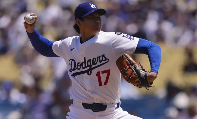 Los Angeles Dodgers starting pitcher Shohei Ohtani throws to the plate during the first inning of a baseball game against the St. Louis Cardinals, Wednesday, Aug. 6, 2025, in Los Angeles. (AP Photo/Mark J. Terrill)