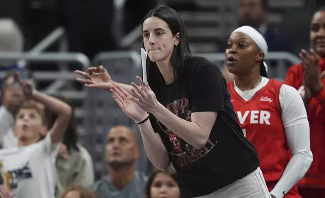 Indiana Fever's Caitlin Clark cheers during the first half of a WNBA basketball game against the Minnesota Lynx, Friday, Aug. 22, 2025, in Indianapolis. (AP Photo/Darron Cummings)
