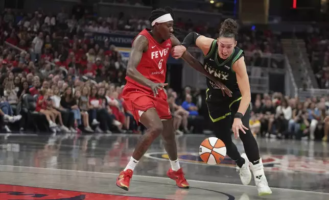 Minnesota Lynx's Jessica Shepard (15) goes to the basket against Indiana Fever's Natasha Howard (6) during the first half of a WNBA basketball game, Friday, Aug. 22, 2025, in Indianapolis. (AP Photo/Darron Cummings)
