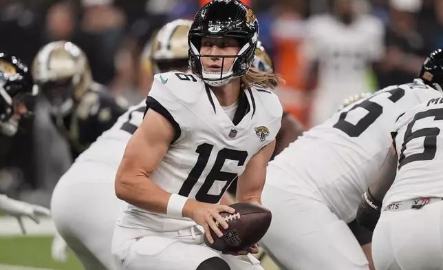 Jacksonville Jaguars quarterback Trevor Lawrence (16) prepares to hand off in the first half of an NFL preseason football game against the New Orleans Saints in New Orleans, Sunday, Aug. 17, 2025. (AP Photo/Gerald Herbert)