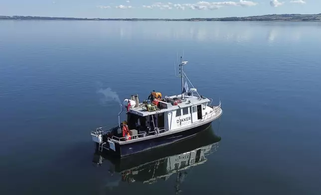 A diving vessel has anchored in Bay of Aarhus as a diver excavates an 8,500-year-old Stone Age coastal settlement below the Bay of Aarhus, Denmark. Aug.18, 2025. (AP Photo/James Brooks)