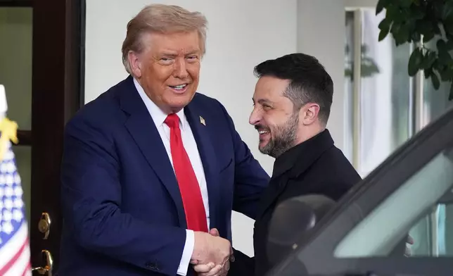 President Donald Trump, left, greets Ukraine's President Volodymyr Zelenskyy as he arrives at the White House, Monday, Aug. 18, 2025, in Washington. (AP Photo/Alex Brandon)