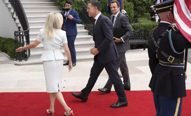 Monica Crowley, White House chief of protocol, from left, greets NATO Secretary General Mark Rutte upon arriving to meet with President Donald Trump and Ukraine's President Volodymyr Zelenskyy, Monday, Aug. 18, 2025, at the South Portico of the White House in Washington. (AP Photo/Jacquelyn Martin)