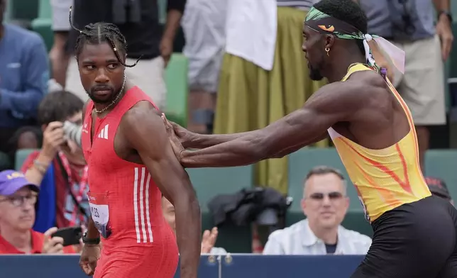 Kenny Bednarek pushes Noah Lyles after the men's 200-meter finals during the U.S. Championships athletics meet in Eugene, Ore.,Sunday, Aug. 3, 2025. (AP Photo/Ashley Landis)